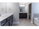 Modern bathroom with black cabinets, double sinks, and tiled floors at 4183 May Apple Ln, Atlanta, GA 30349