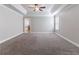 Spacious primary bedroom with tray ceilings and wall-to-wall carpeting at 4183 May Apple Ln, Atlanta, GA 30349