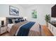 Cozy bedroom featuring a plush bed with stylish blue accents and natural light at 140 Racine Sw St, Atlanta, GA 30314