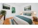 Cozy bedroom with a white bed, turquoise accents and two pieces of artwork adorning the walls at 140 Racine Sw St, Atlanta, GA 30314