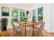 Dining room with a wooden table and beige upholstered chairs illuminated by lots of natural light at 140 Racine Sw St, Atlanta, GA 30314
