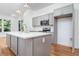 Modern kitchen featuring gray cabinets, a white countertop island and stainless steel appliances at 140 Racine Sw St, Atlanta, GA 30314