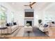 Bright living room featuring a modern fireplace, light hardwood floors, and stylish furniture with pops of navy at 140 Racine Sw St, Atlanta, GA 30314