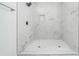Walk-in shower with large marble-like tiles and a built-in niche at 140 Racine Sw St, Atlanta, GA 30314