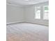 Bedroom with soft carpet, two windows, and neutral colors at 162 Bluffington Way, Marietta, GA 30066