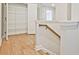 Hallway with open closet, wood floors, and a view of other rooms at 162 Bluffington Way, Marietta, GA 30066