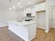 Modern kitchen features an island with quartz countertop and built-in stainless steel appliances at 162 Bluffington Way, Marietta, GA 30066