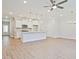 Bright, open-concept kitchen with white cabinets, island, pendant lighting and stainless steel appliances at 162 Bluffington Way, Marietta, GA 30066
