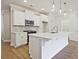 Bright, open-concept kitchen with white cabinets, island, stainless steel appliances, and modern fixtures at 162 Bluffington Way, Marietta, GA 30066
