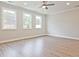 Bright living room with recessed lighting, wood-look floors, and three windows at 162 Bluffington Way, Marietta, GA 30066