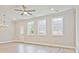 Bright living room with recessed lighting, a ceiling fan, multiple windows, and wood-look floors at 162 Bluffington Way, Marietta, GA 30066