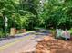 Scenic park entrance featuring a tree-lined road, natural stone accents, and inviting signage for outdoor adventures at 162 Bluffington Way, Marietta, GA 30066