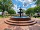 Charming town square featuring a tiered fountain, brick walkways, manicured landscaping, and a gazebo for community gatherings at 162 Bluffington Way, Marietta, GA 30066