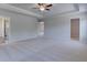 Spacious main bedroom with tray ceiling, plush carpet and ensuite bathroom and walk-in closet at 257 Chiswick Loop, Stockbridge, GA 30281
