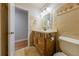Bathroom featuring a carved wood vanity with sink, and tiled walls at 288 Shire Way, Lawrenceville, GA 30044