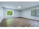 Large bedroom with ceiling fan, hardwood floors, neutral paint and big windows overlooking a serene wooded area at 288 Shire Way, Lawrenceville, GA 30044