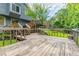 Large wooden deck with multiple levels, overlooking green backyard and mature trees at 288 Shire Way, Lawrenceville, GA 30044