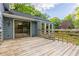 Wooden deck with railings overlooking grassy yard and wooded views, with easy access to inside at 288 Shire Way, Lawrenceville, GA 30044