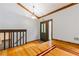 Inviting foyer with decorative lighting, wooden trim, and hardwood floors leading to the staircase at 288 Shire Way, Lawrenceville, GA 30044