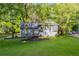 Charming home with fresh curb appeal, green lawn, mature trees, and a driveway at 288 Shire Way, Lawrenceville, GA 30044