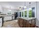 Bright kitchen boasts white cabinetry, granite counters, stainless appliances, and a view of lush greenery at 288 Shire Way, Lawrenceville, GA 30044
