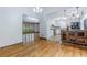 Open concept living room featuring hardwood floors and chandelier, adjacent to the kitchen with stainless steel appliances at 288 Shire Way, Lawrenceville, GA 30044