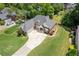 Aerial view of a well-maintained home with a spacious driveway and green lawn at 5791 Epping Ct, Douglasville, GA 30135
