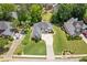 Aerial view of a lovely home with lush landscaping and a curved driveway at 5791 Epping Ct, Douglasville, GA 30135