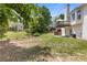 Lush backyard featuring a deck, manicured lawn, and mature trees at 5791 Epping Ct, Douglasville, GA 30135