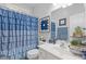 Charming bathroom with blue shower curtain and a stylish vanity at 5791 Epping Ct, Douglasville, GA 30135