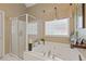 Relaxing bathroom with a separate shower and soaking tub, enhanced by natural light at 5791 Epping Ct, Douglasville, GA 30135