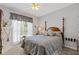 Cozy bedroom featuring a comfortable bed, neutral tones, and sunny windows at 5791 Epping Ct, Douglasville, GA 30135