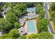 Aerial view of community pool and tennis courts bordered by mature trees and landscaping at 5791 Epping Ct, Douglasville, GA 30135