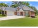 Beautiful brick home with attached garage, wide driveway, landscaped lawn, and mature trees at 5791 Epping Ct, Douglasville, GA 30135