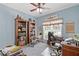 Comfortable home office with bookshelves and a desk next to a sunny window at 5791 Epping Ct, Douglasville, GA 30135