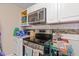 A kitchen with modern appliances, light cabinets, and mosaic backsplash at 5791 Epping Ct, Douglasville, GA 30135