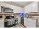 Kitchen featuring stainless steel appliances, mosaic backsplash, and modern cabinets at 5791 Epping Ct, Douglasville, GA 30135