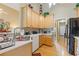 Well-lit kitchen featuring wooden cabinets and views into the living spaces at 5791 Epping Ct, Douglasville, GA 30135