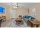 The living room features a large grey sofa, blue accent pillows, and a golf tournament on television at 5791 Epping Ct, Douglasville, GA 30135