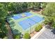 Aerial view of community tennis courts with a blue surface, green border and surrounding trees at 5791 Epping Ct, Douglasville, GA 30135