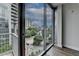 Balcony view overlooking the city with lush greenery, high-rise buildings, and a bright sky at 950 W Peachtree Nw St # 911, Atlanta, GA 30309