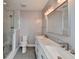 Bright bathroom with double sinks, marble counters, and a glass shower at 950 W Peachtree Nw St # 911, Atlanta, GA 30309