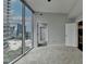 Bedroom features wall to wall windows with city views and neutral carpet at 950 W Peachtree Nw St # 911, Atlanta, GA 30309