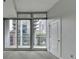 Bright bedroom featuring large windows with city views at 950 W Peachtree Nw St # 911, Atlanta, GA 30309