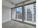 Bright bedroom featuring large windows and a balcony with city views at 950 W Peachtree Nw St # 911, Atlanta, GA 30309