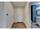 Inviting hallway with hardwood floors, leading to a bathroom with stylish blue accent wall at 950 W Peachtree Nw St # 911, Atlanta, GA 30309