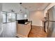 Modern kitchen with stainless steel appliances, black countertops, and an island open to the living area at 950 W Peachtree Nw St # 911, Atlanta, GA 30309
