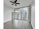 Bright living room featuring hardwood floors, ceiling fan, and floor to ceiling windows with a city view at 950 W Peachtree Nw St # 911, Atlanta, GA 30309