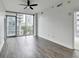 Spacious living room with a large window providing an urban view and stylish hardwood floors at 950 W Peachtree Nw St # 911, Atlanta, GA 30309