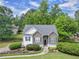 Aerial view of home showcasing lush landscaping, stone accents, and a well-manicured lawn at 100 Sydney Smt, Villa Rica, GA 30180